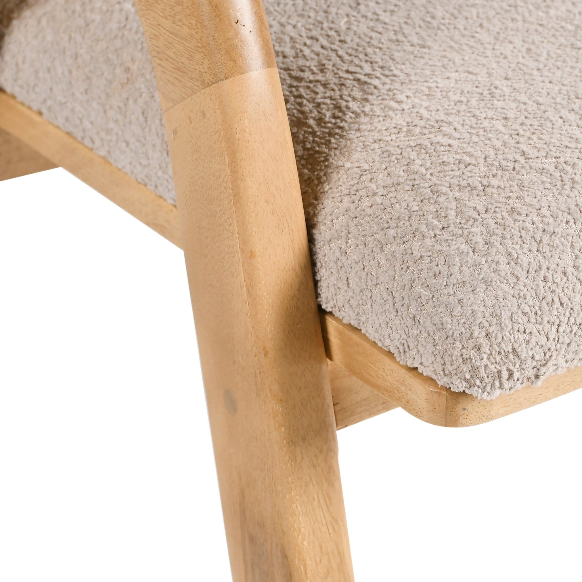 Close-up of a wooden chair with a textured beige cushion