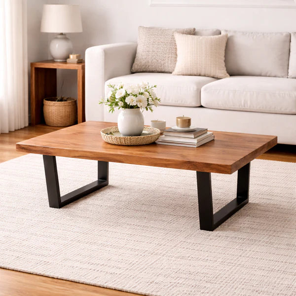 Modern live edge acacia coffee table with black metal base in living room