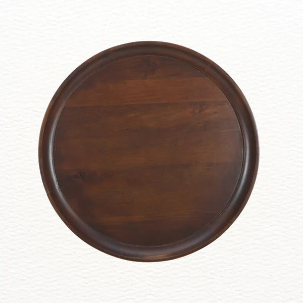 Top view of round mango wood coffee table showing smooth grain and finish