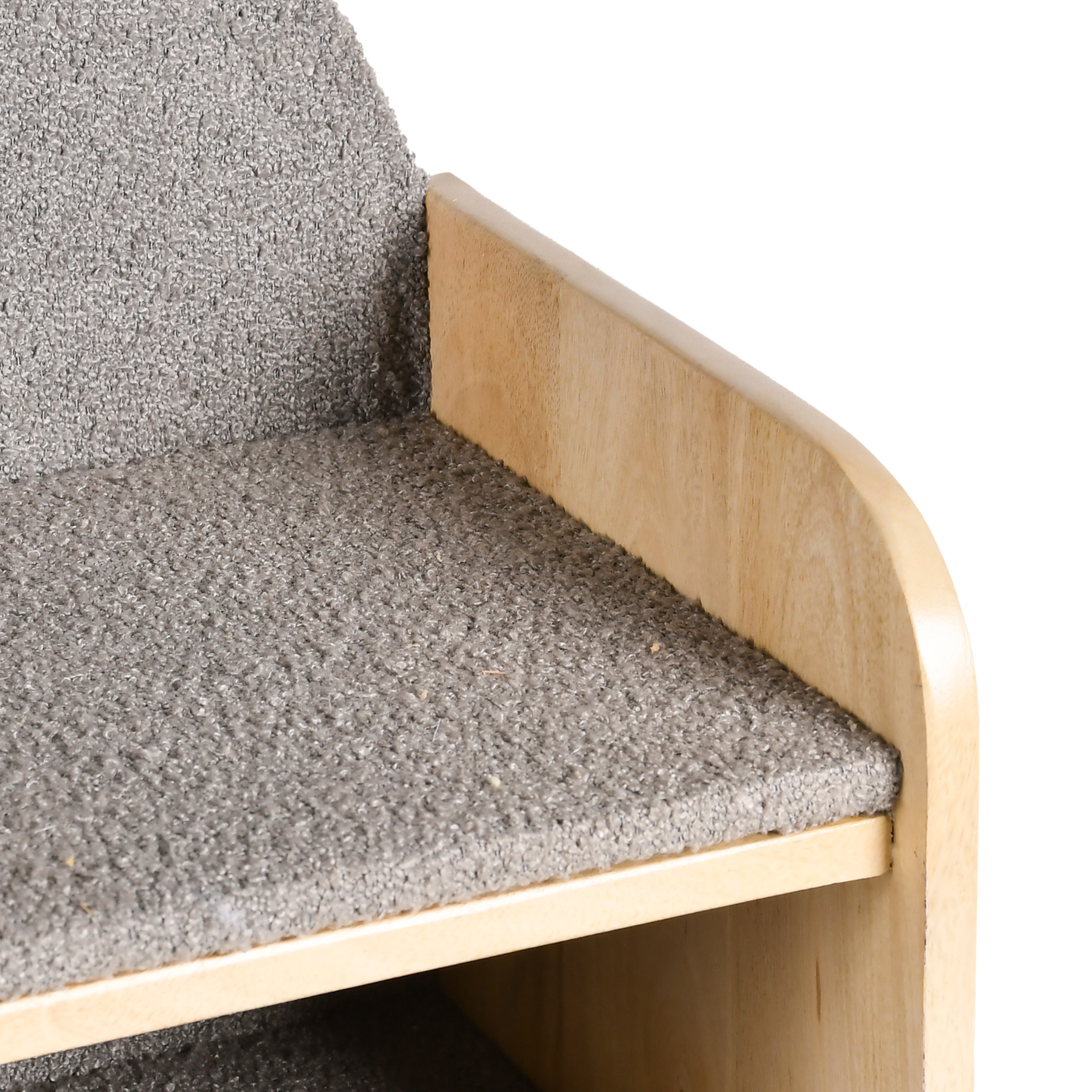 Close-up detail of grey upholstered surface and wooden side panel of Caddy Kids Storage Bookshelf