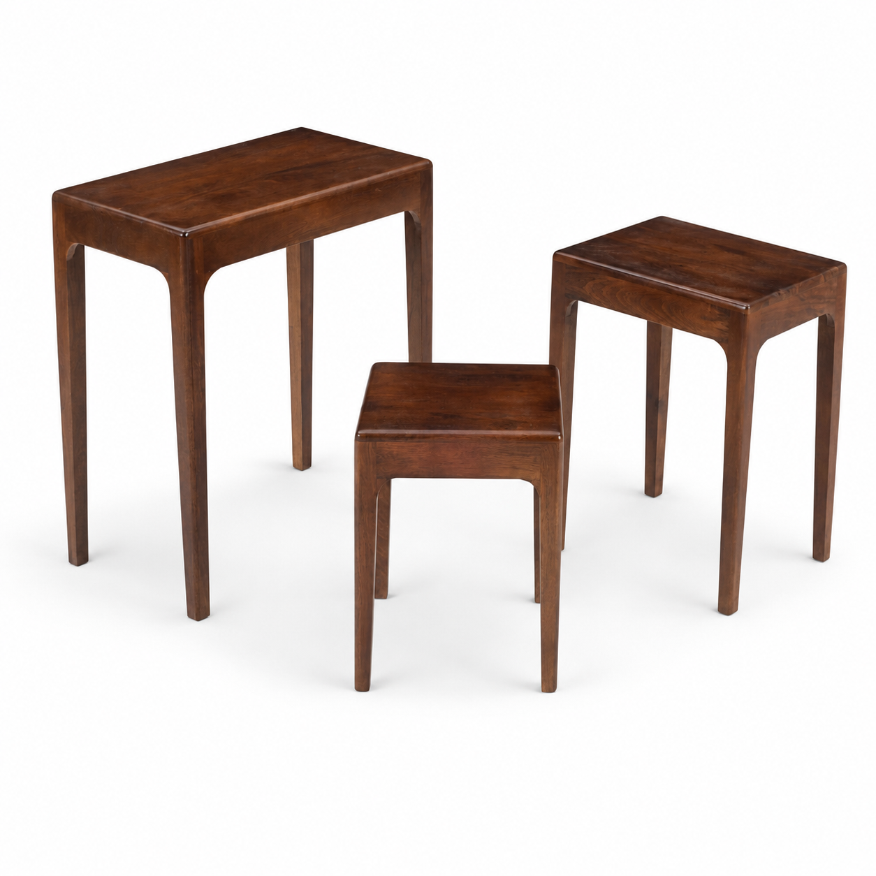 Three nested wooden nesting tables in varying sizes with a warm dark brown finish, shown on a clean white background.
