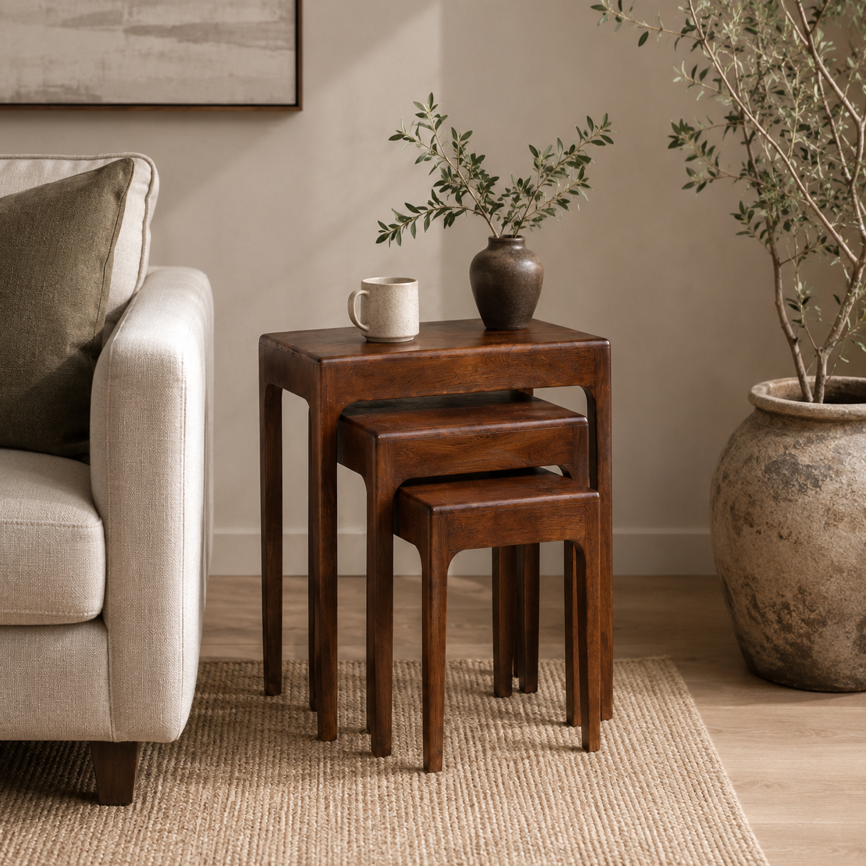 Mango wood Cadence nesting table set styled with home decor in a living room