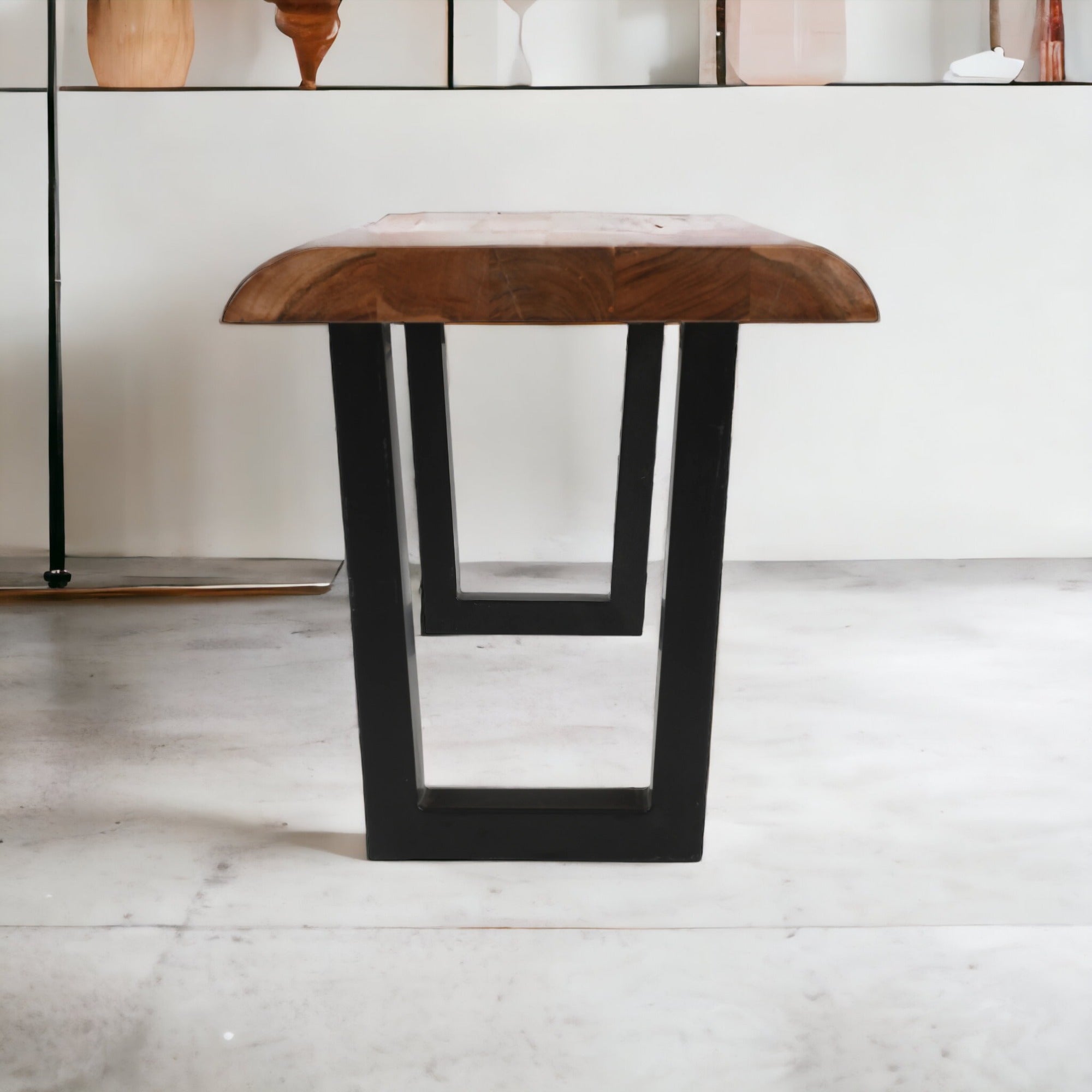 angle view of live edge acacia wood bench with U metal legs natural brown finish