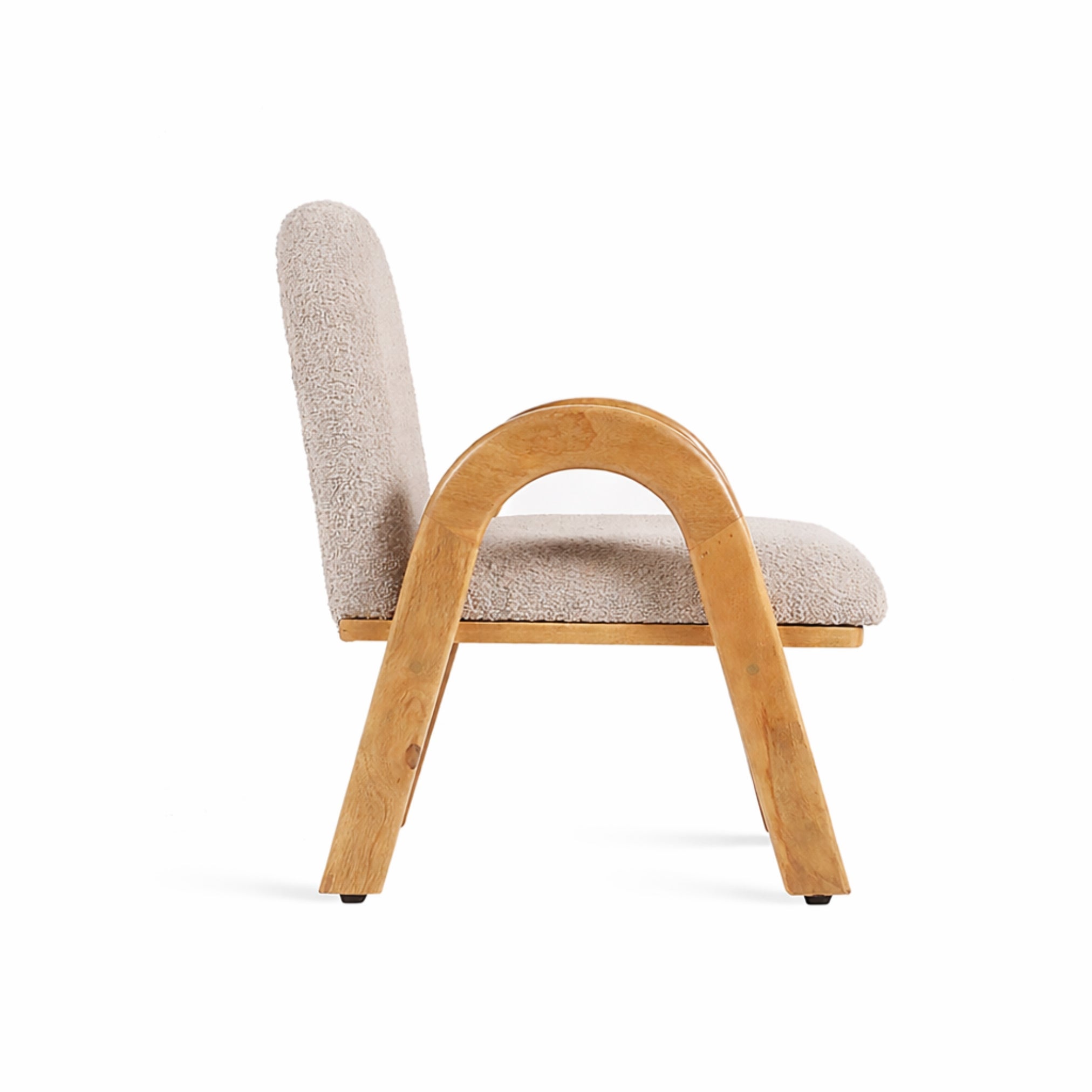 Side view of Mysa upholstered wooden kids lounge chair highlighting curved wooden armrest and compact design