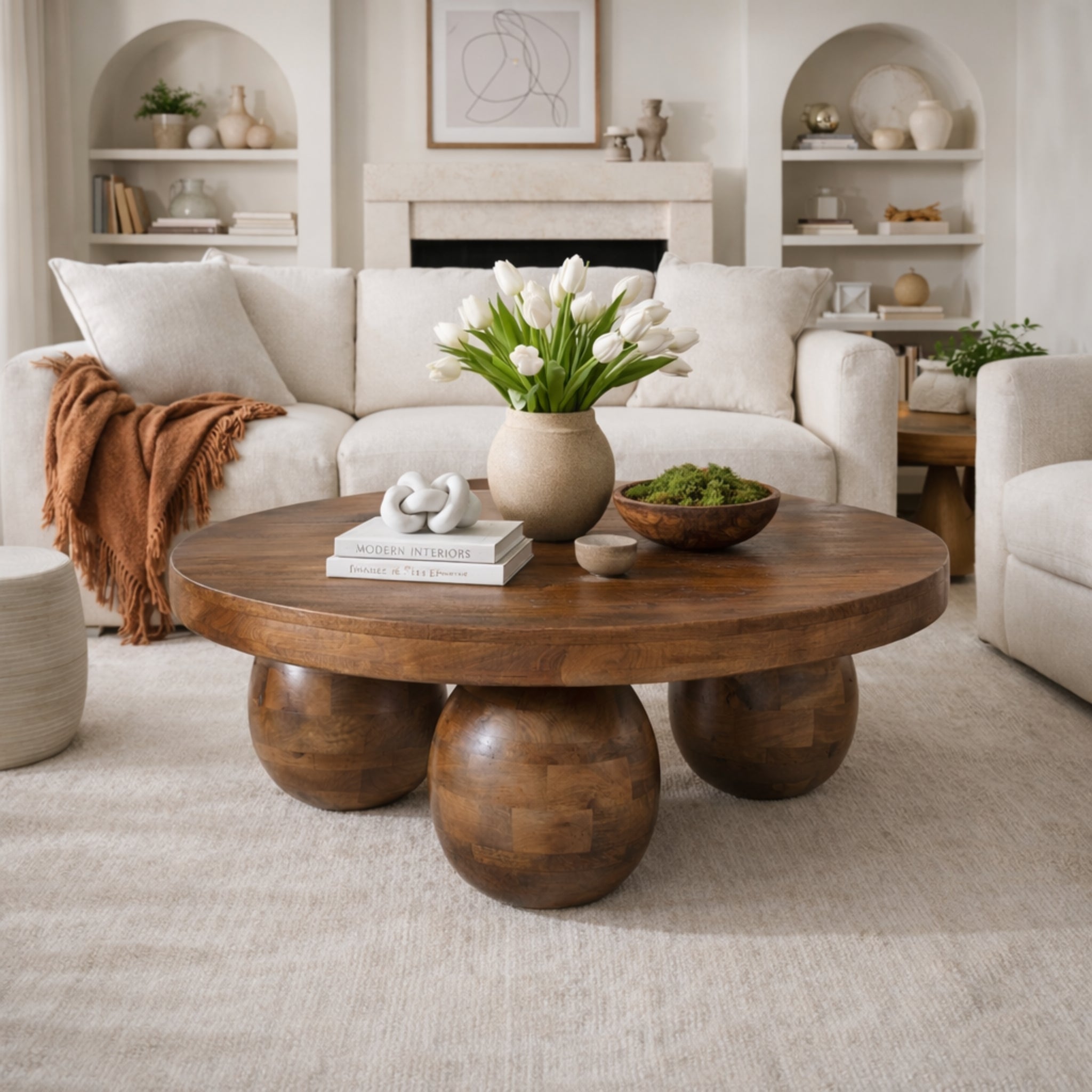 solstice round mango wood coffee table with unique spherical base design for living room