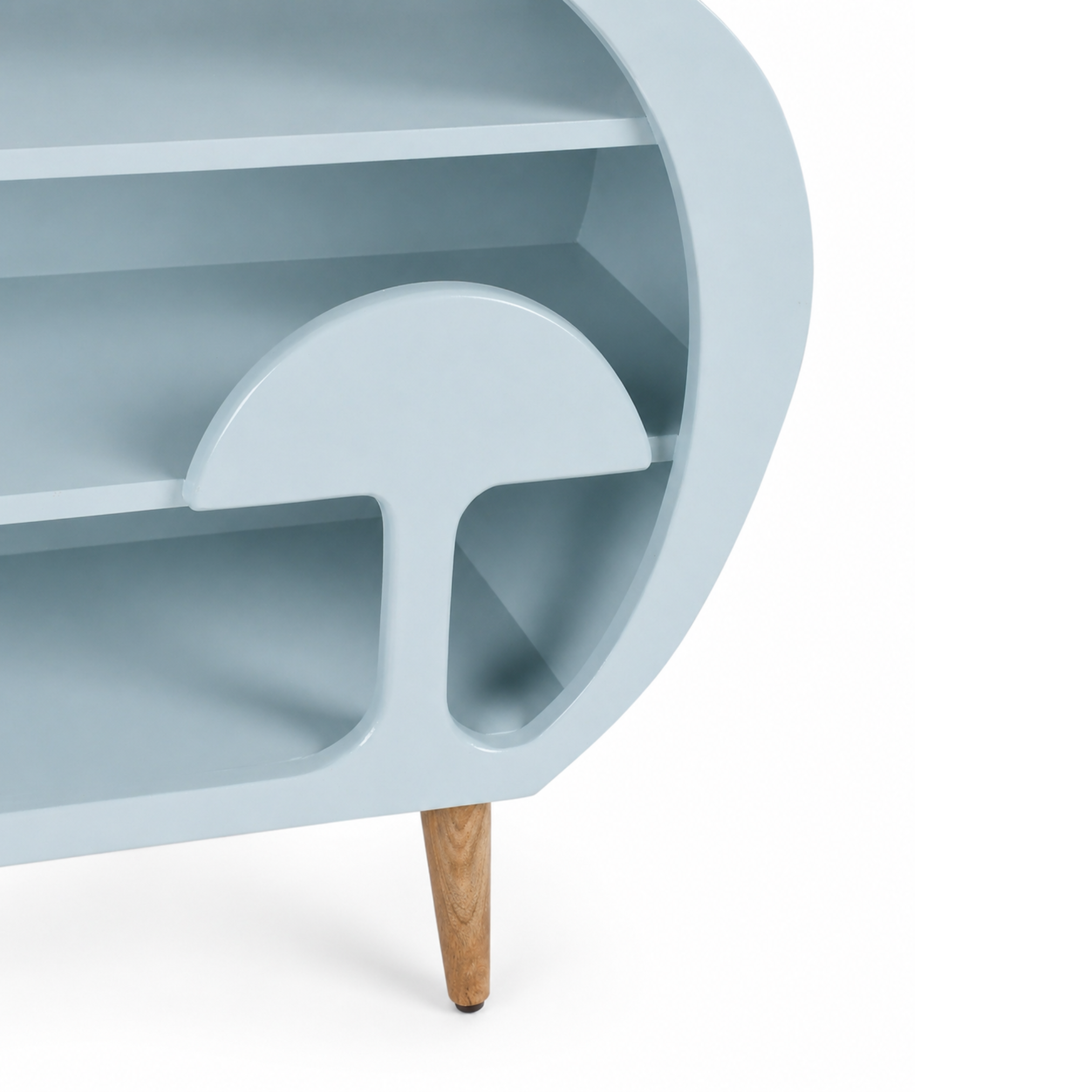 Close-up of curved shelf design in truffle wooden kids bookshelf showing smooth finish and unique divider
